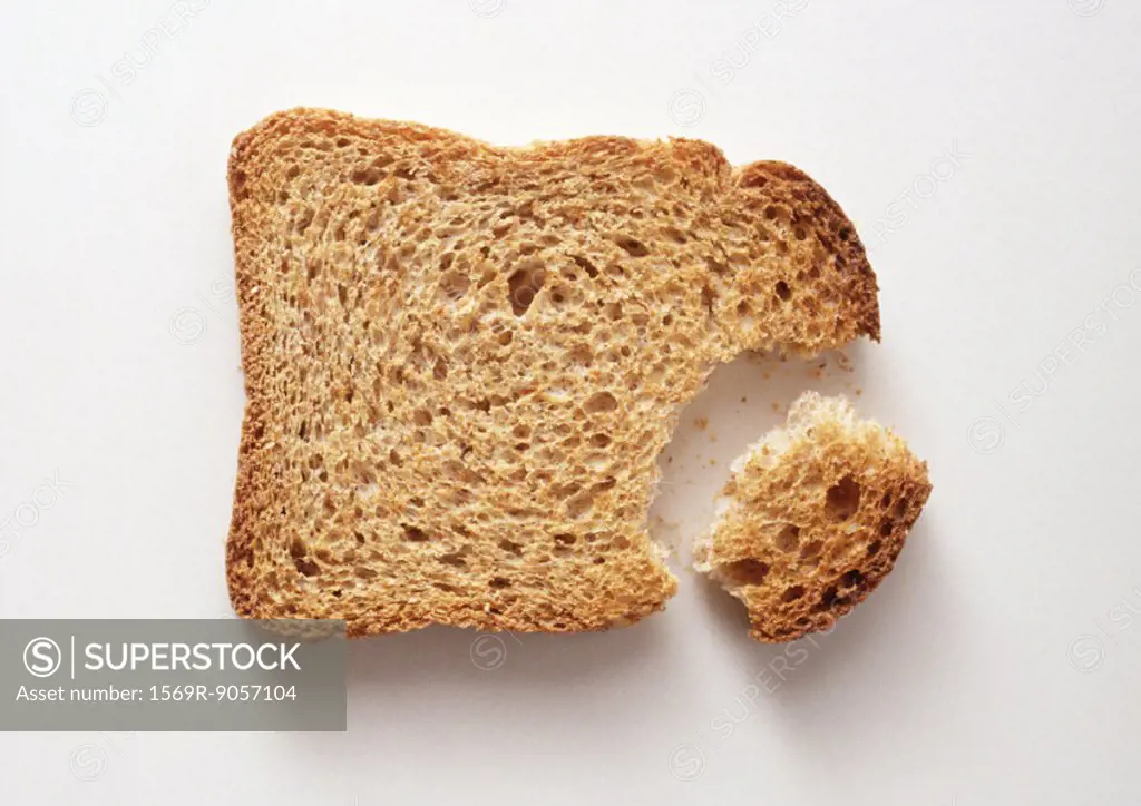Slice of bread with piece broken off, close-up