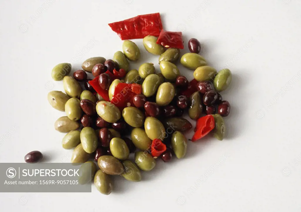 Pile of spicy green and black olives, white background