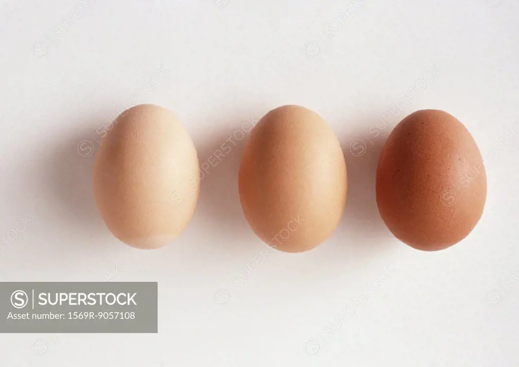 Three eggs against white background, close-up