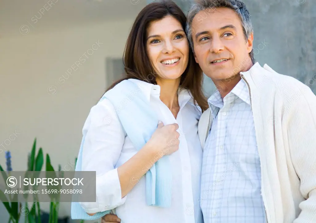Mature couple standing together, smiling