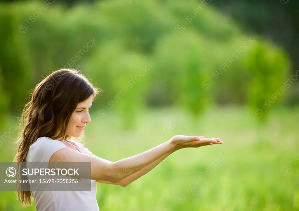 Young woman holding palms up