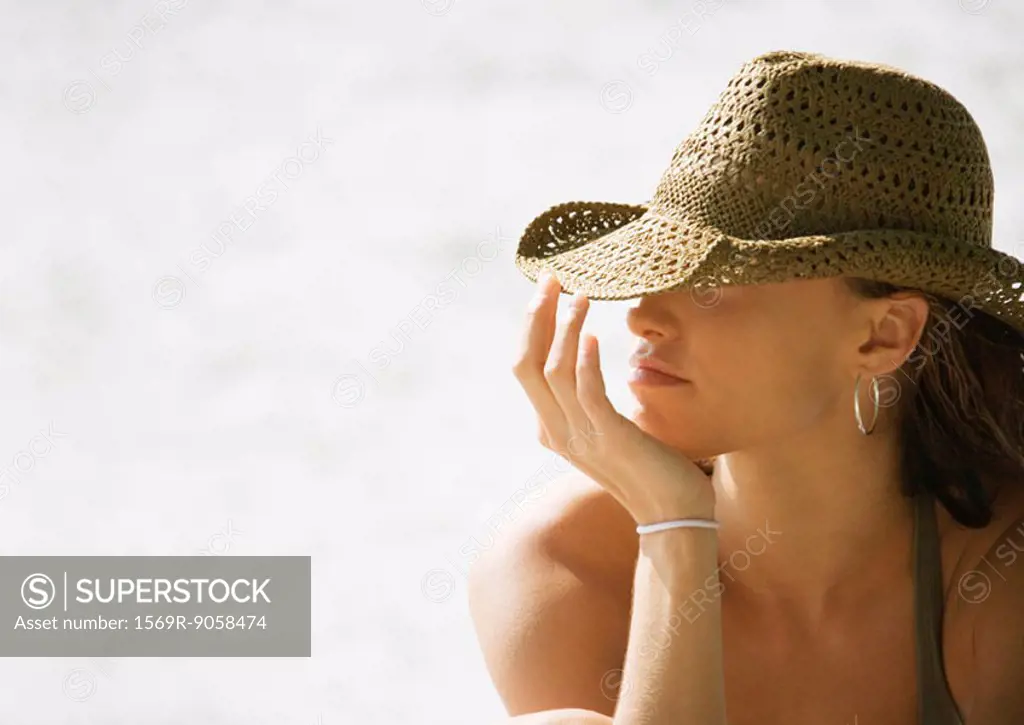 Young woman wearing sun hat