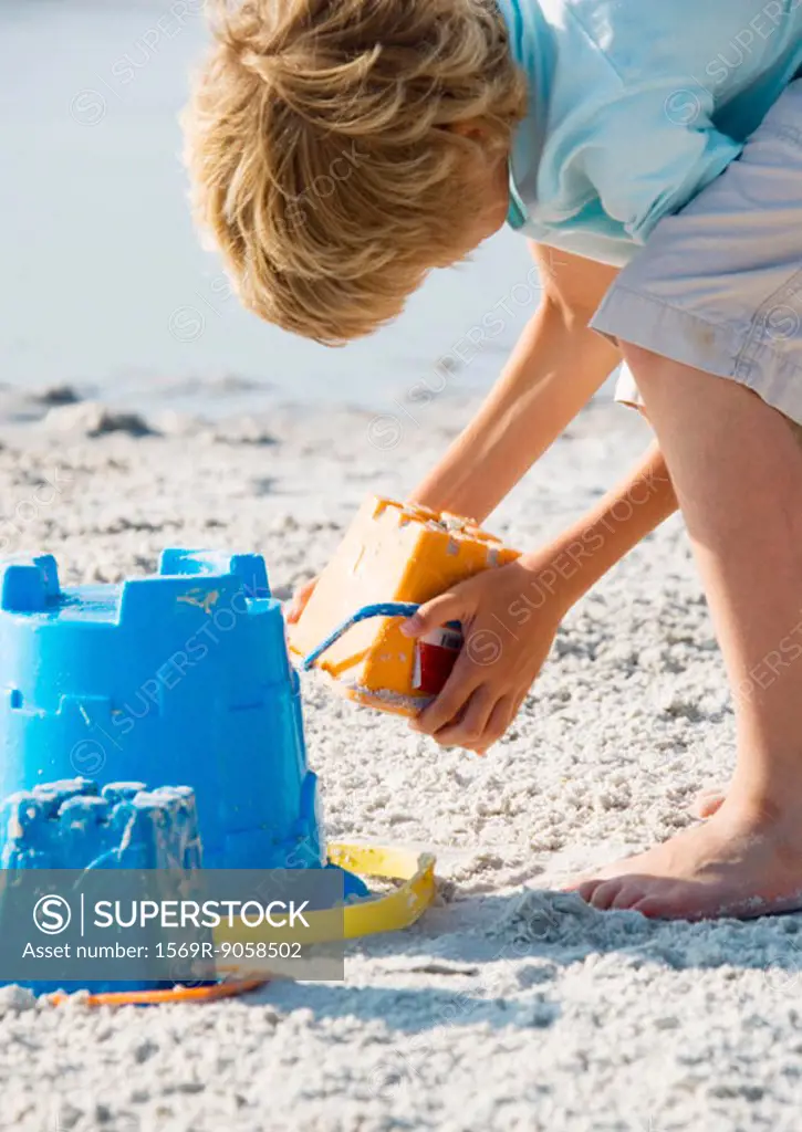 Child making sand castle