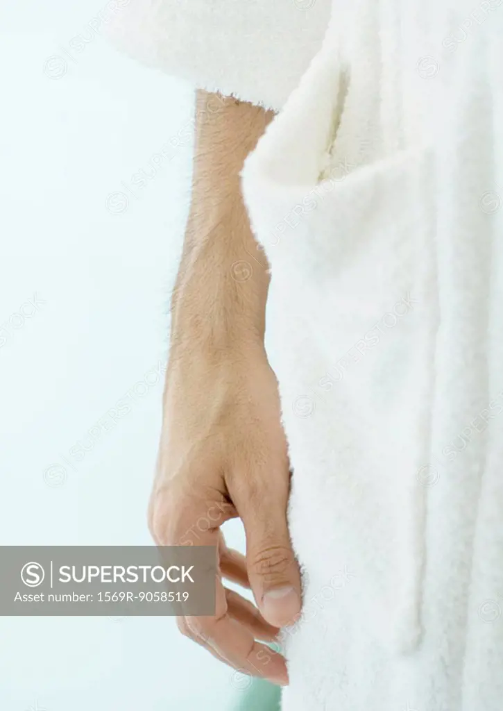 Close-up of man´s hand next to bathrobe