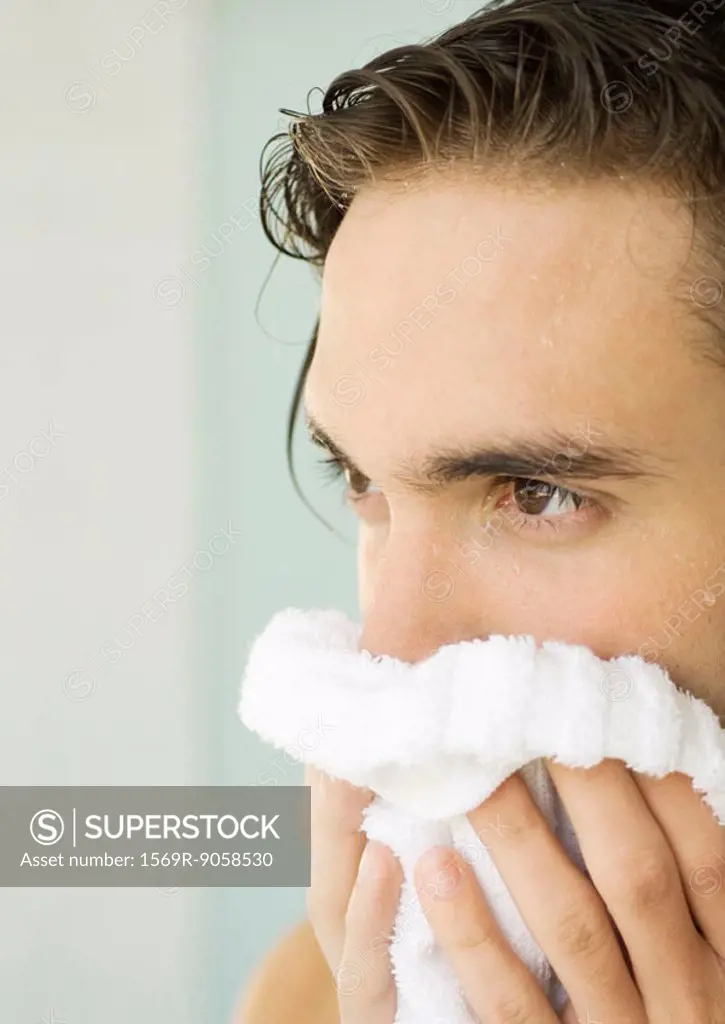 Man drying face with towel