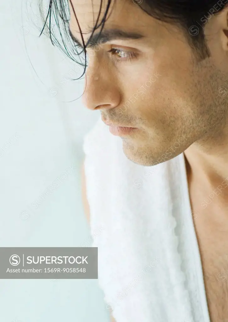 Man with wet hair and towel over shoulder