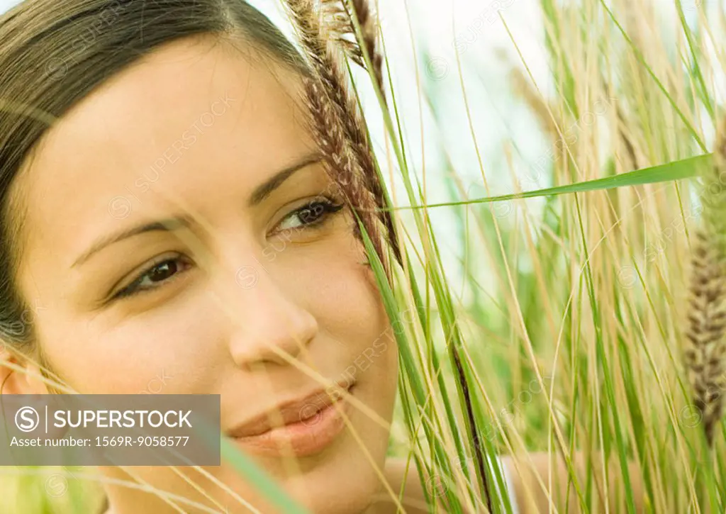 Woman´s face in long grass