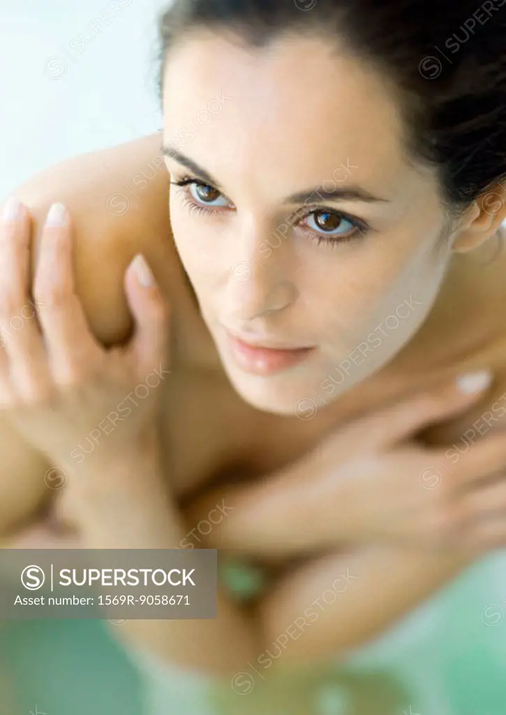 Woman crossing arms over chest, high angle view
