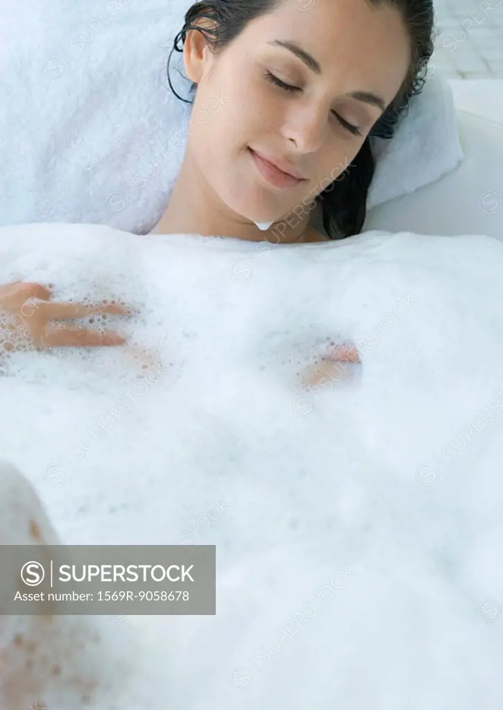 Woman reclining in bubble bath