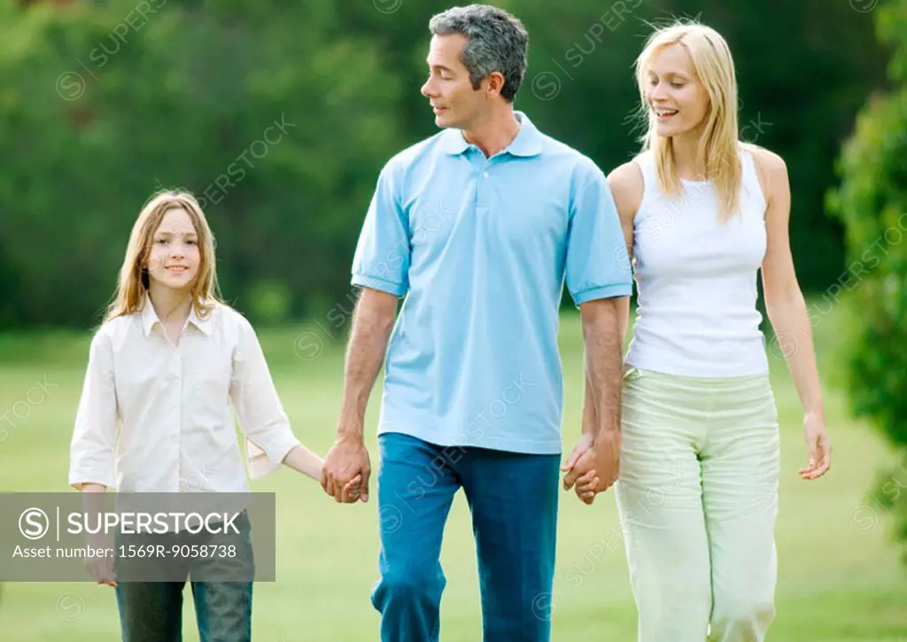 Girl taking walk with parents
