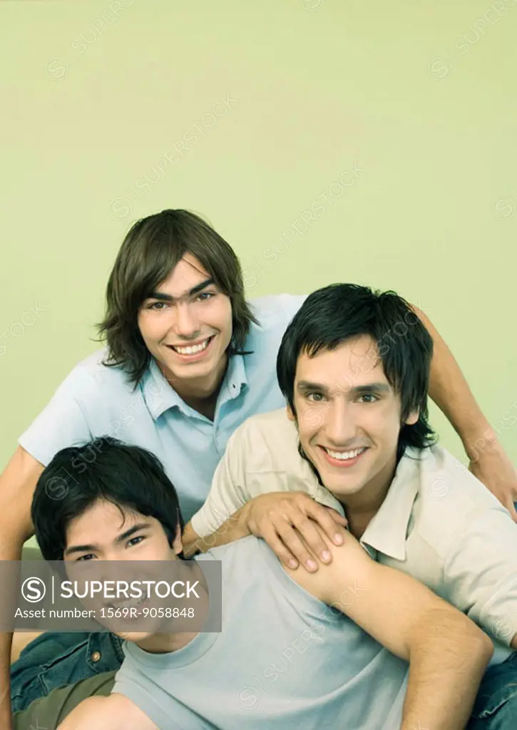 Three young male friends smiling, portrait