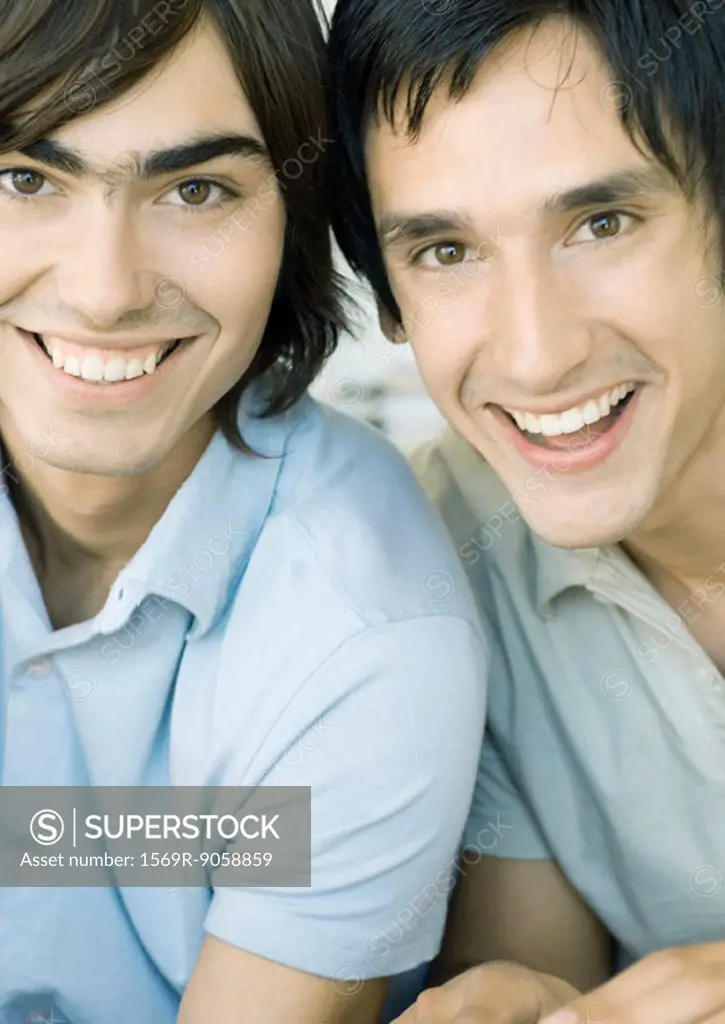 Two young men smiling