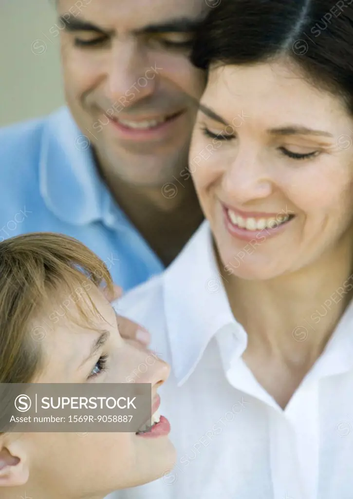 Family with one child, mother and daughter looking at each other, smiling, close-up