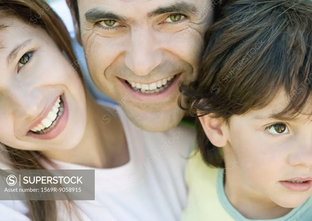 Father with two children, boy looking away, father and daughter smiling and looking at camera, portrait, close-up
