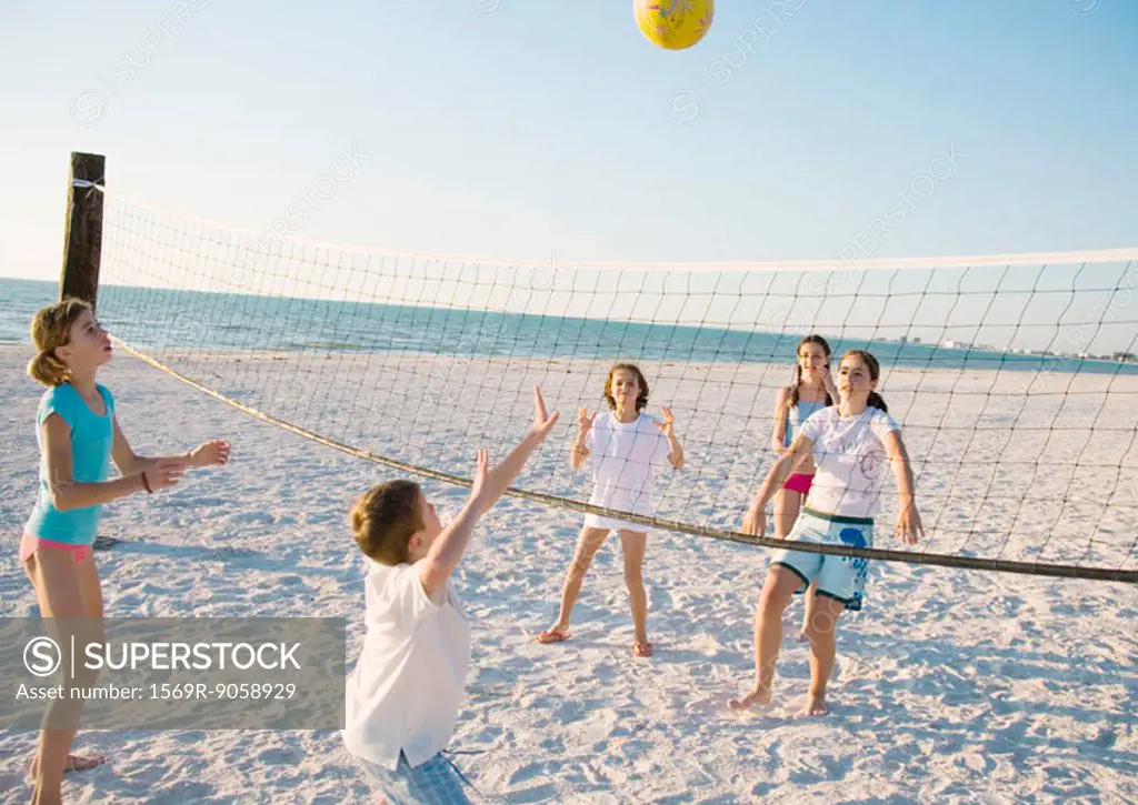 Group of kids playing beach volleyball