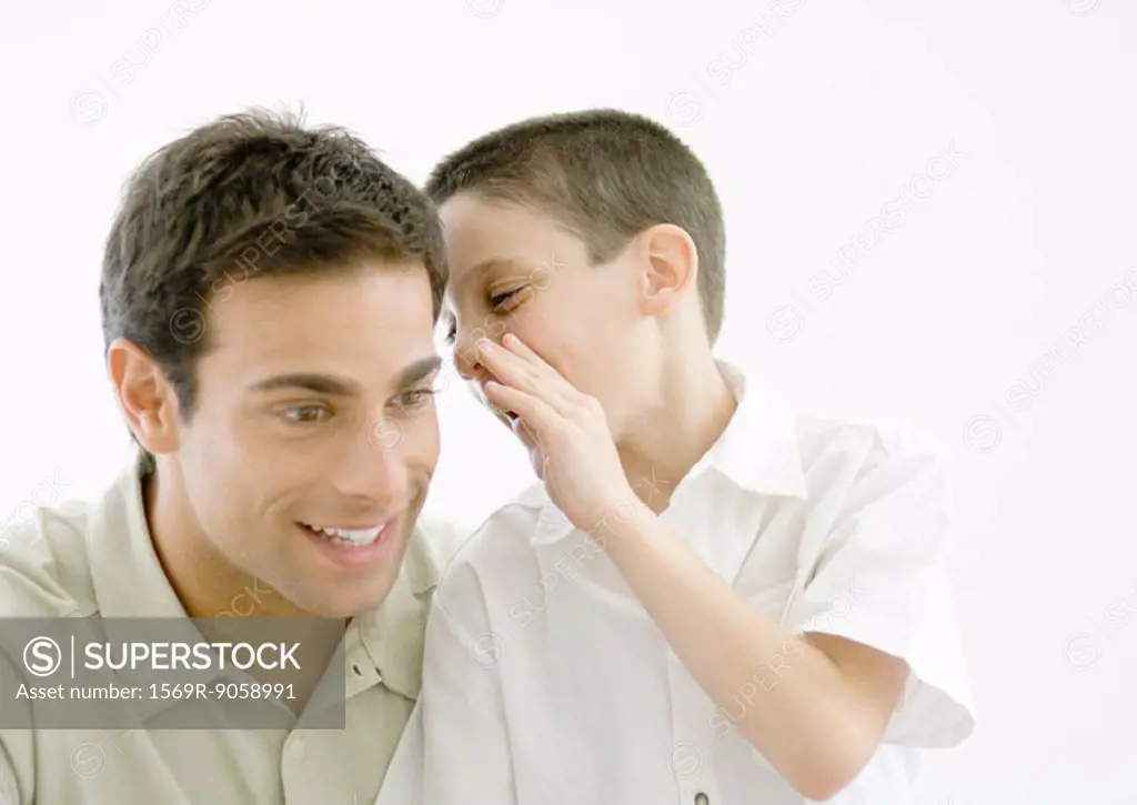 Boy whispering to father