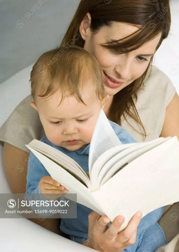 Mother reading book to baby