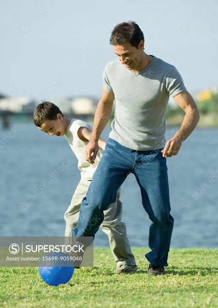 Man and son playing soccer