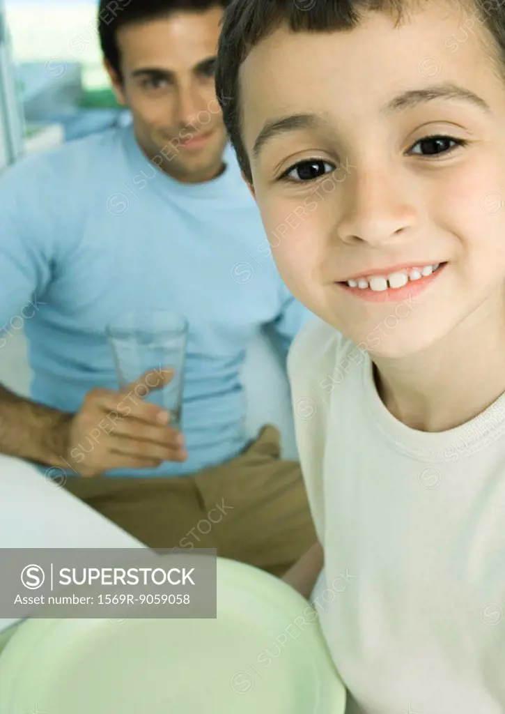 Boy and father with dishes