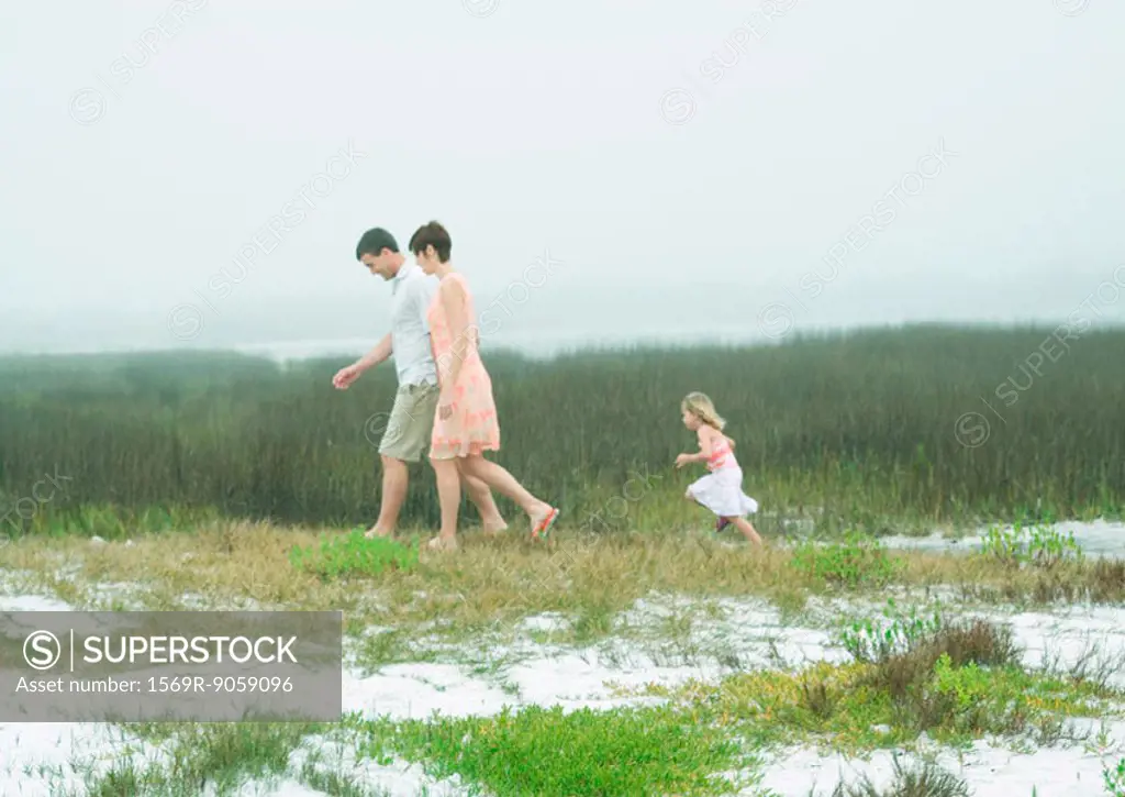 Family taking walk in coastal area