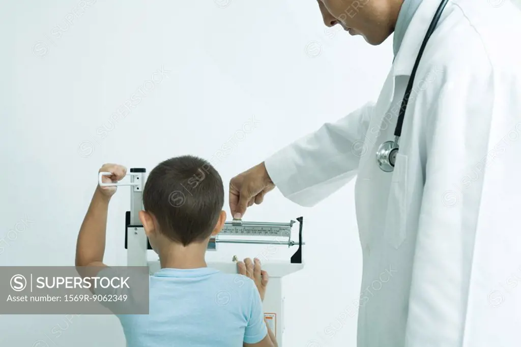 Boy standing on scale at doctor´s office