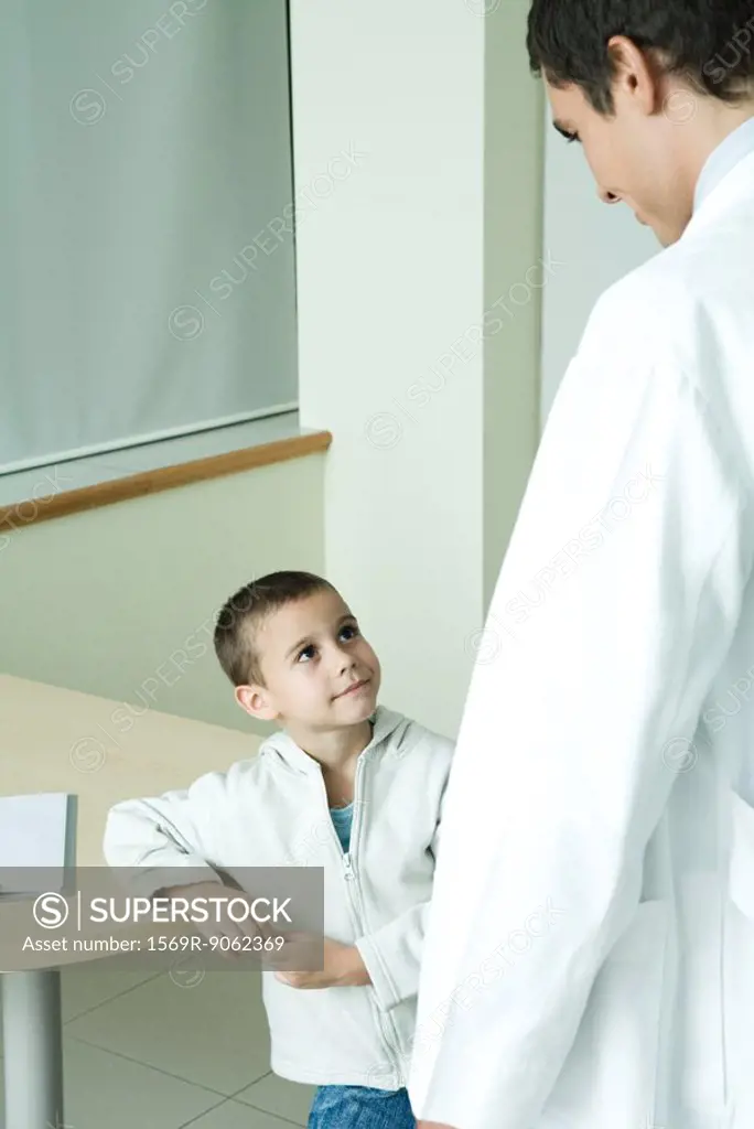 Boy looking up at doctor in doctor´s office