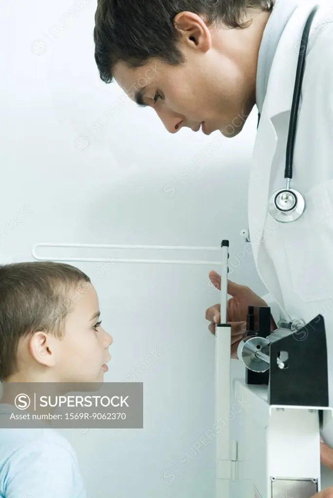Doctor measuring boy´s height