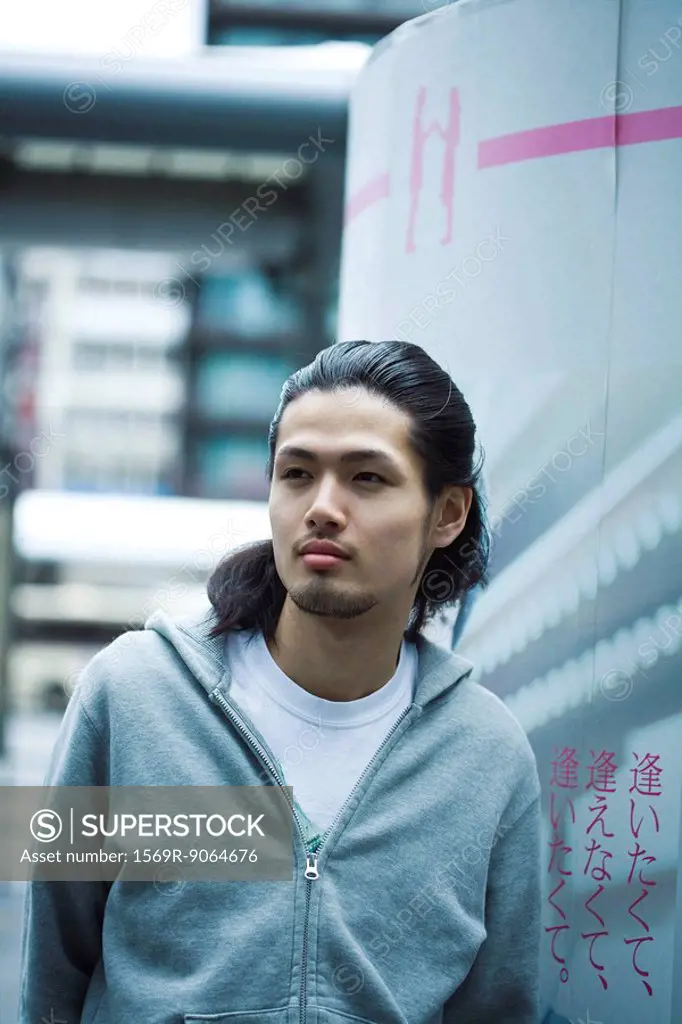 Young male wearing sweatshirt, looking away