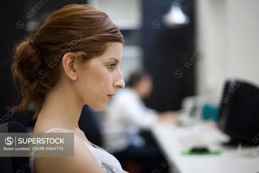 Woman working at desk, profile