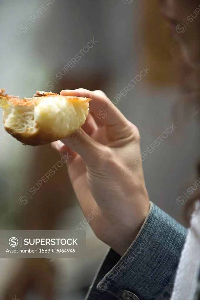 Woman´s hand holding croissant, close-up