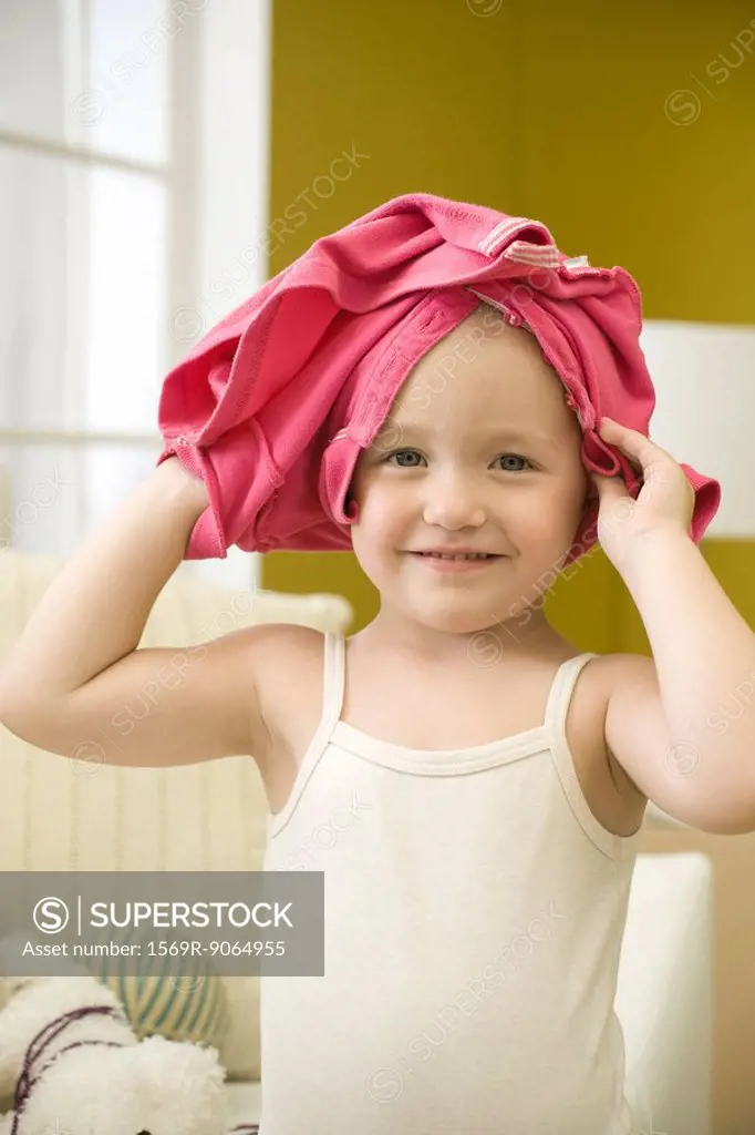 Toddler girl with shirt on head, portrait