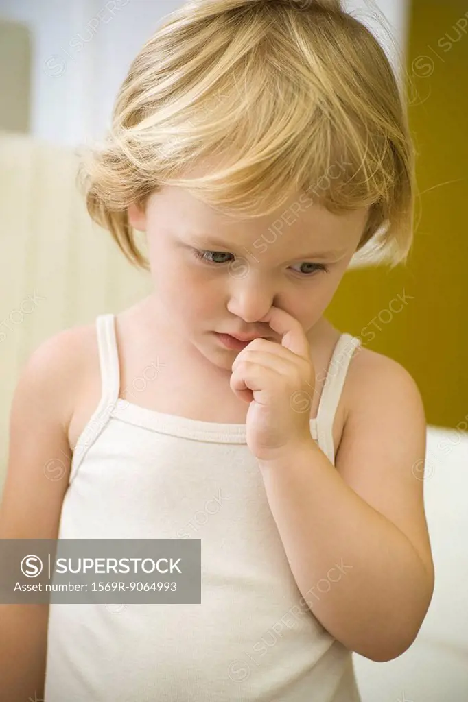 Little girl picking nose
