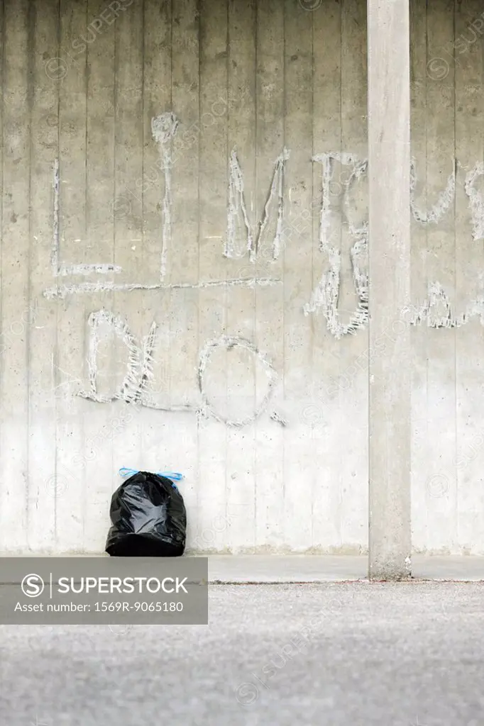 Bag of garbage leaning against wall