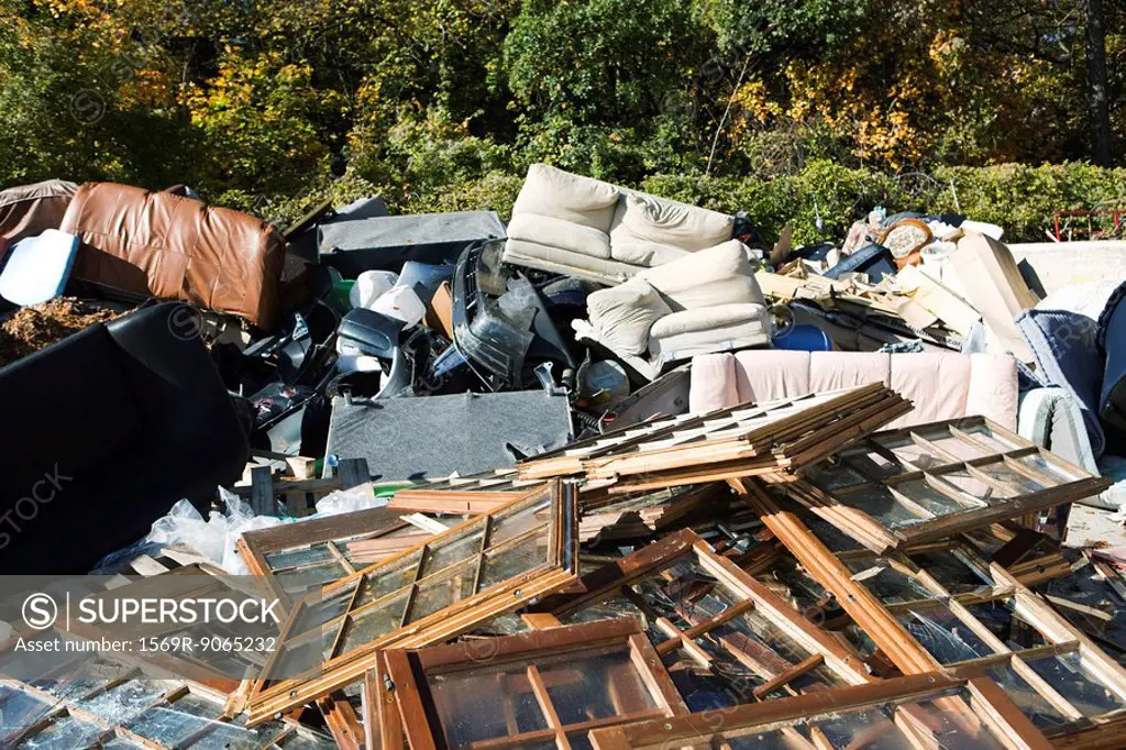 Discarded windows and furniture in large junk heap