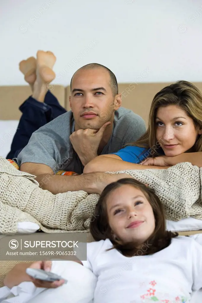 Family relaxing, watching TV together