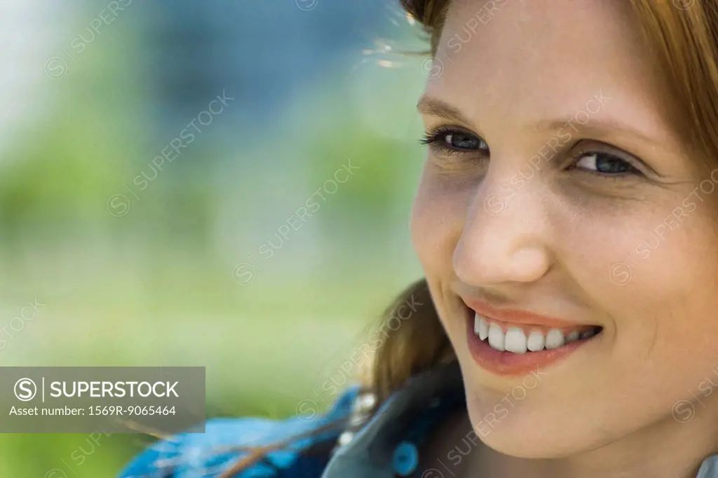 Young woman looking away, smiling, portrait