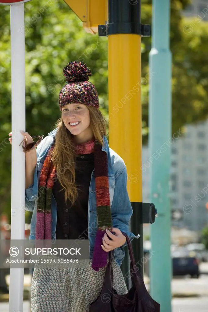Young woman in trendy clothing, smiling
