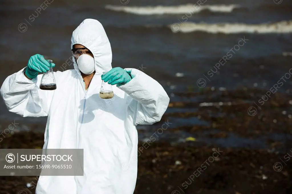 Person in protective suit testing polluted water