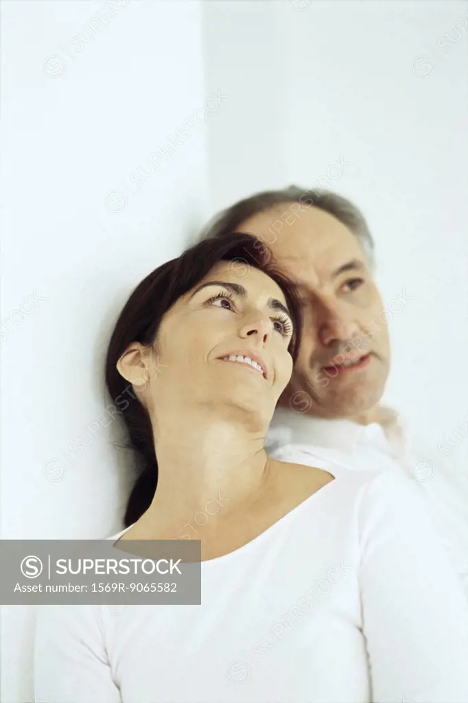Mature couple leaning against one another