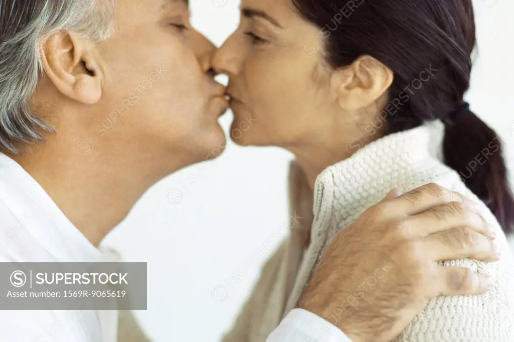 Mature couple kissing, close-up