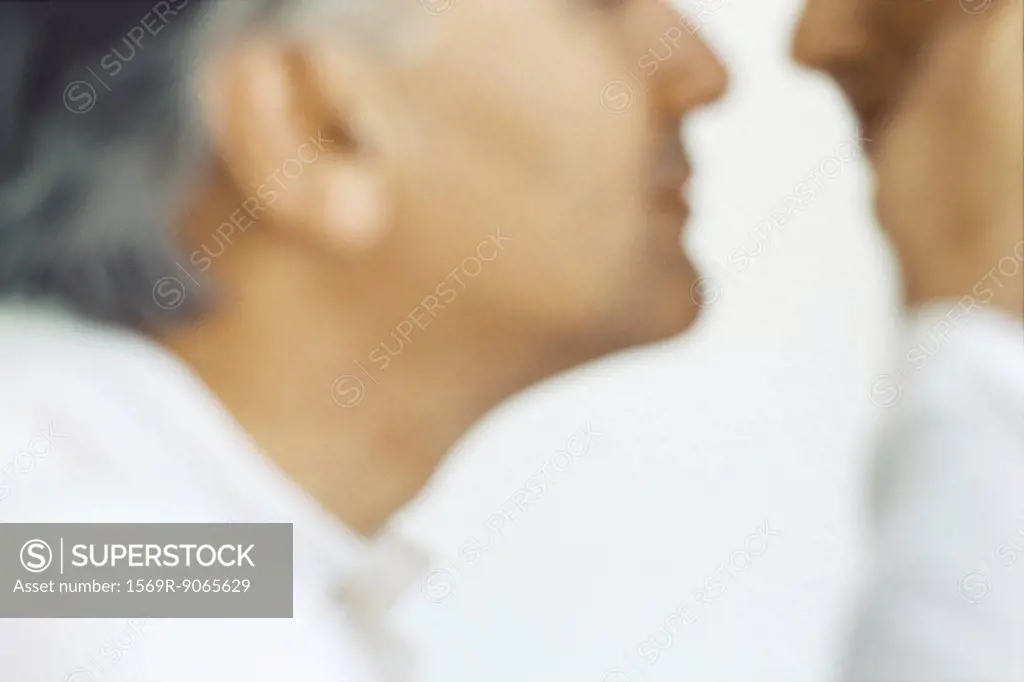 Senior man placing hand on wife´s cheek, cropped