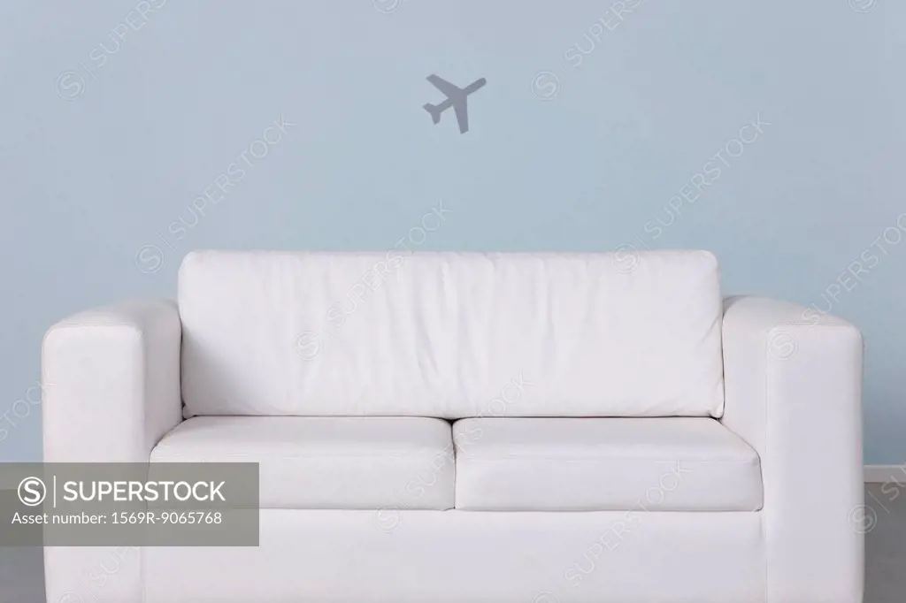 Sofa and airplane shape in background
