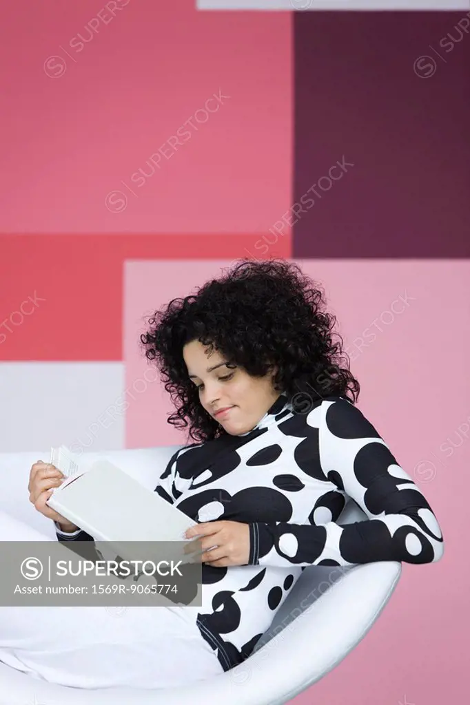 Young woman relaxing with book