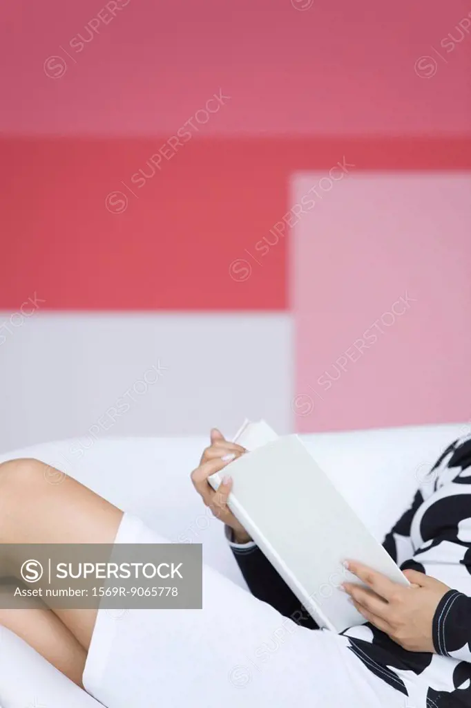 Young woman relaxing with book