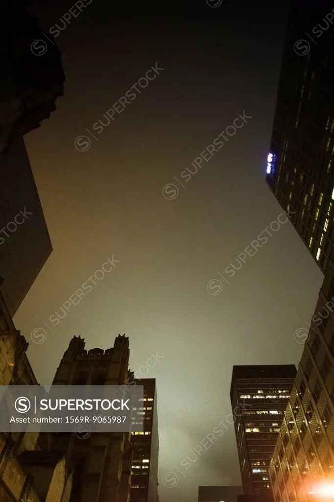 Foggy night view of high rise buildings, church