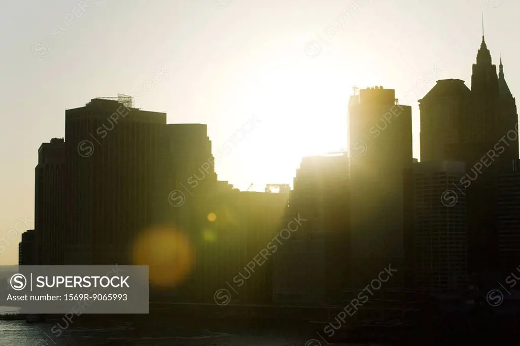 Silhouette of city skyline at sunset