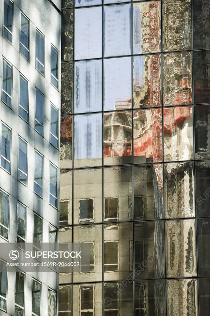 Reflection of building on widows of steel and glass high rise office building, cropped