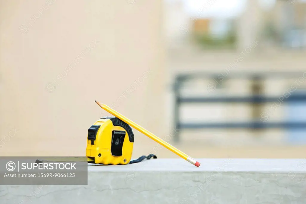 Measuring tape with pencil on ledge