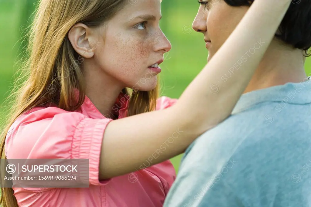Young couple staring into each other´s eyes, side view