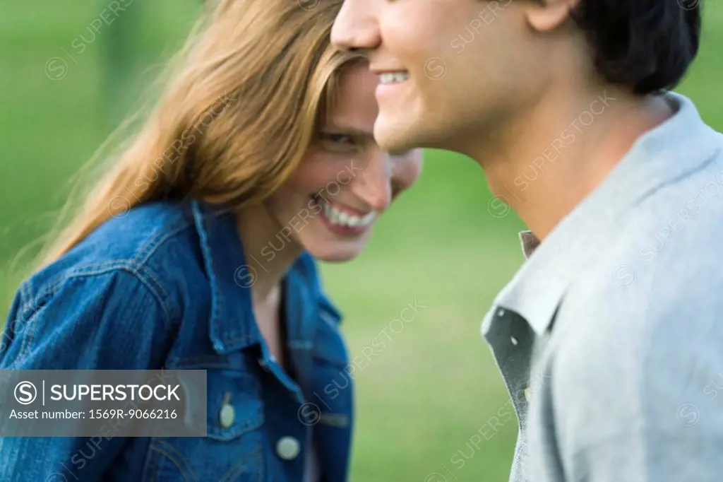 Young couple laughing, cropped